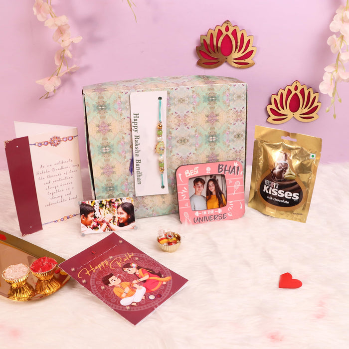 Art Street Rakshabandhan Gift Hamper with Sweets for Brother and Bhabhi, Megantice Photo Frame and Lotus Flowers Rakhi with Chawal and Roli Gift Set for Celebrate Raksha Bandhan (Pack of 7 Items)