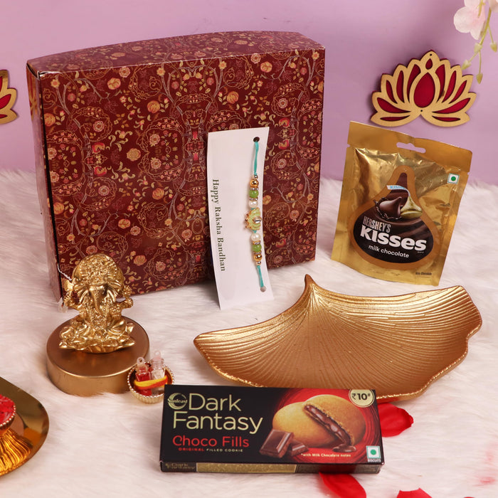 Rakshabandhan Chocolate Gift Hamper for Brother and Bhabhi, Plate and Shree Ganesh Ji Idol, Lotus Flowers Rakhi with Chawal and Roli Gift Set for Celebrate Raksha Bandhan